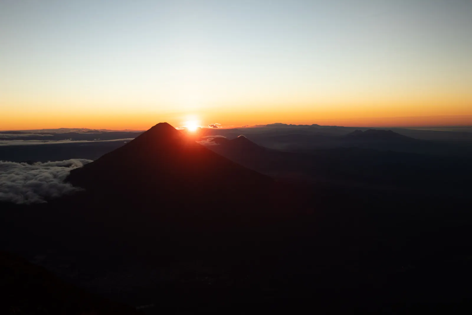 Sunrise above a sea of clouds seen from Acatenango volcano